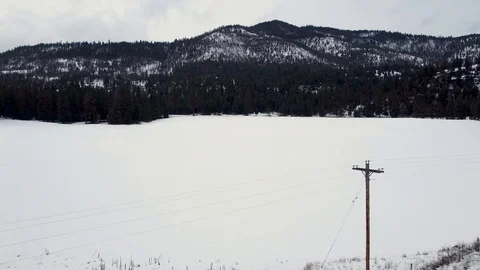 Overhead tracking shot over snow covered pasture Stock Footage 124666731