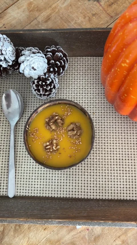 Overhead tracking shot of pumpkin soup with autumn decor 스톡 동영상 339779920