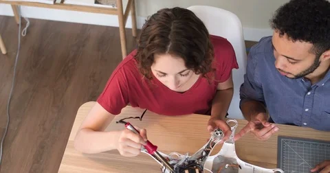 Overhead Tracking Shot Of Two Young Software Engineers Testing A Robot Stock Footage 82671341