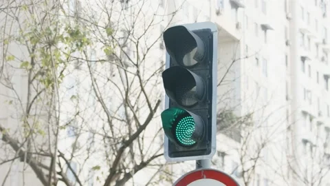 The overhead traffic lights are red, then turn green, in the city streets Stock Footage 171378512