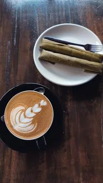 Overhead vertical view of cappuccino paired with suman malagkit  Stock Photos