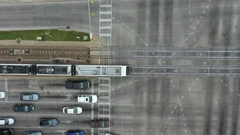 Overhead video of train on tracks going through intersections with cars Stock Footage 164331251