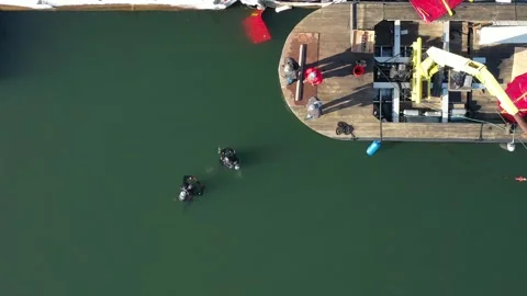 Overhead View Of 2 Divers  In The Water Prior To Sunken Boat Recovery. 4K Stock Footage 152423300