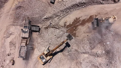 Overhead view of an active mining quarry with heavy machinery including Stock Footage 337229532