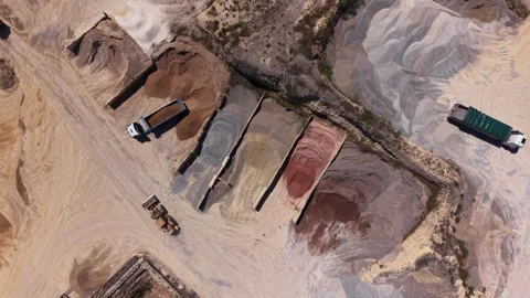 Overhead view of an active sand and gravel quarry with dump trucks, a loader Stockbeeldmateriaal 341468393