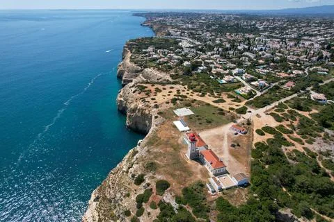 Overhead view of the Algave coast featuring pleasure boats and the Farol de.. Stock Photos
