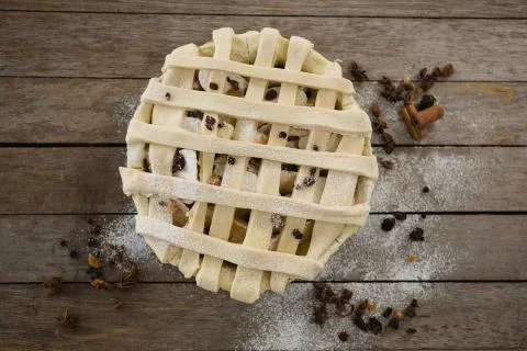 Overhead view of apple pie in baking pan by spices Stock Photos