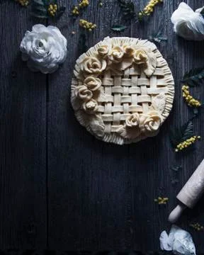 Overhead view of apple pie ready to bake placed on wooden table Stock Photos