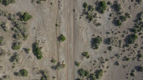 Overhead view of ATV driving up across Nevada desert Stock Footage 107693588