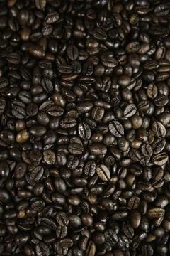 Overhead view of backdrop representing halves of dark brown coffee beans. Tex 스톡 사진