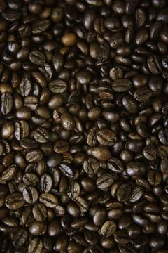 Overhead view of backdrop representing halves of dark brown coffee beans. Tex Foto stock