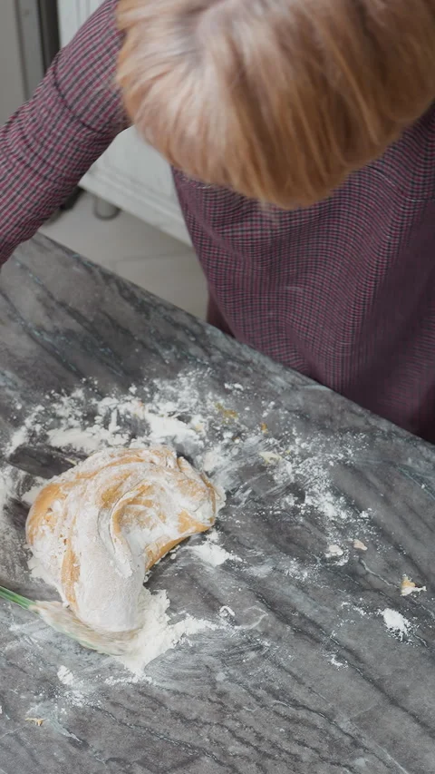 Overhead View of Baker Kneading Dough on Floured Tiled Table Stock Footage 320339449