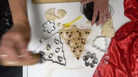 Overhead view of a baking process with hands preparing a Christmas tree-shaped Stock Footage 336066183