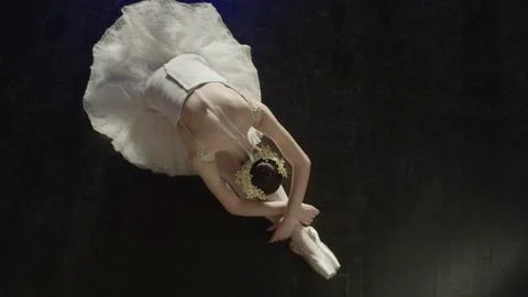 Overhead view of ballet dancer stretching in costume before show 스톡 사진