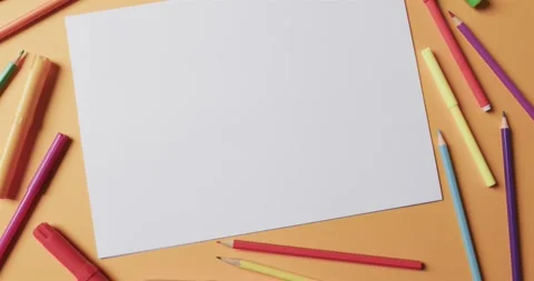 Overhead view of blank sheet of paper with school stationery on beige Stock Footage 331208443