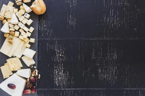 Overhead view bread with different type cheese with grapes black textured 스톡 사진