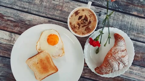 Overhead view of breakfast with fried egg toast and coffee on wooden table Video stock 340879868