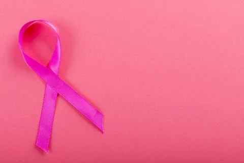 Overhead view of breast cancer awareness pink ribbon isolated over pink Stock Photos