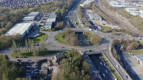 Overhead view of a busy roundabout in the midlands, motorway traffic Stock Footage 105510248