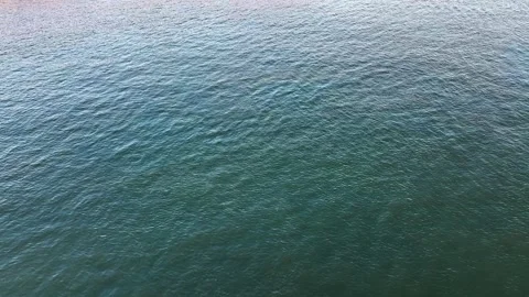 Overhead view of calm, rippling blue-green sea surface, textured waves Stock Footage 313981026
