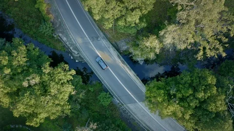 Overhead View of Car Crossing the Bridge Over The Creek. Zoom out Spinning Sh Stock Footage 113639614