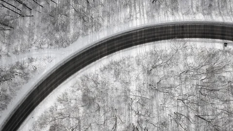 Overhead view of car driving through winter forest Video stock 101057125