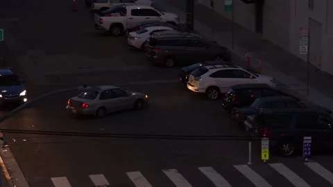 Overhead view of car reversing out of parking space at night. San Francisco, USA Stock Footage 233897227