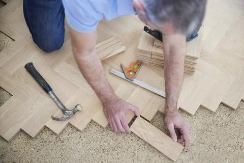 Overhead View Of Carpenter Or Builder Laying New Wood Block Parquet Parquet F Stock Photos