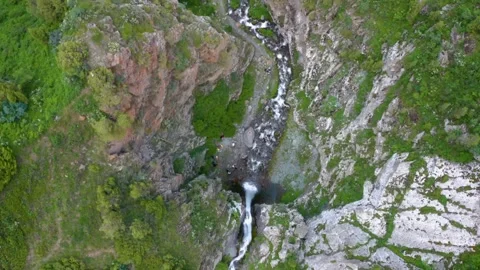 Overhead View of a Cascading Waterfall on a Rocky Cliff in Kyrgyzstan’s Barskoon Stock Footage 306617842