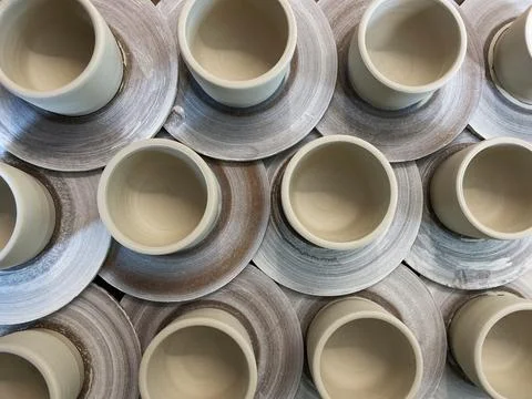 Overhead view of ceramic cups ready to go in a pottery kiln Stock Photos