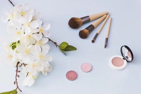 Overhead view cherry blossom makeup brush blusher colored background Stock Photos