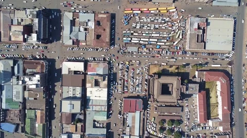 Overhead view of a city intersection with buildings, cars, and people on a Stock Footage 318373424