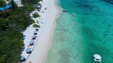 Overhead view of coastal dome surrounded by parasols and loungers 스톡 동영상 347398698