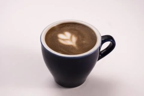 Overhead view of coffee with foam latte art on white background. Overhead c.. Foto stock