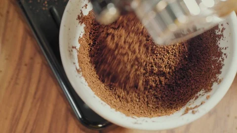 Overhead View of Coffee Grinder Dispensing Fresh Grounds Stock Footage 129303430