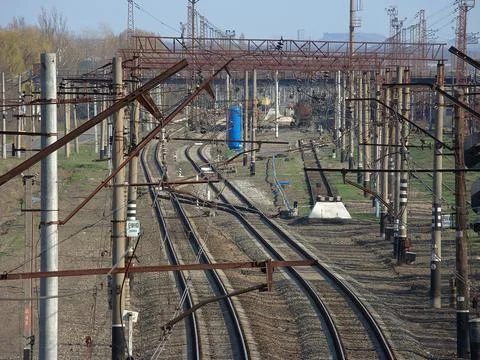 Overhead view of a complex railway yard with multiple tracks, a small blue st Stock Photos