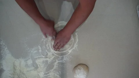 Overhead view of a cook creating flat pizza dough from dough balls. Top down Video stock 149111158