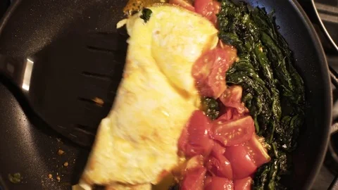 Overhead view of cook plating the eggs tomatoes and spinach 4k Stock Footage