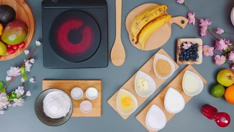 Overhead view of cooking ingredients and electric cooktop on gray surface Stock Footage 342936888