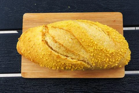 Overhead view of a croatian corn bread loaf placed on a wooden cutting boar.. Stock Photos