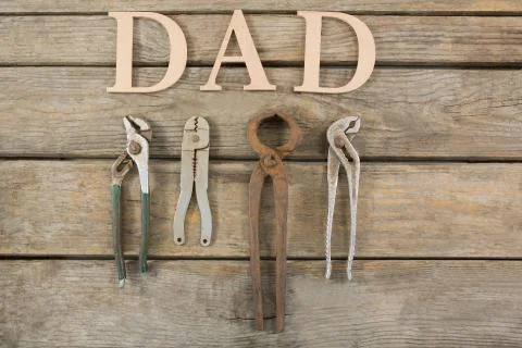 Overhead view of dad text with work tools on table Stock Photos
