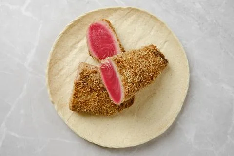 Overhead view of deliciously breaded fish fillet served on a stone plate Stock Photos