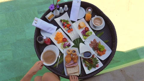 Overhead view of diverse breakfast spread on sunny terrace with Stock Footage 274891459