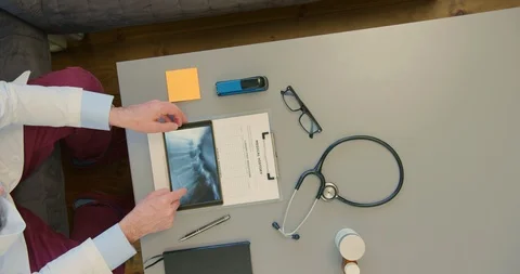 Overhead View Of Doctor Analyzing Brain Scan On Digital Tablet 4K Stock Footage 92177368