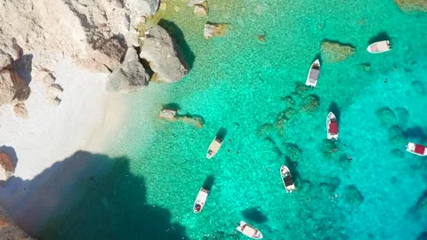 Overhead view drone of boats lined up in a small bay natural port harbor in sea Stock Footage 291270661