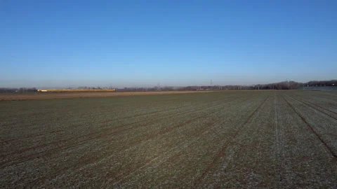Overhead View of Dutch Train Gliding Across Icy Meadow Stock-Footage 241114868
