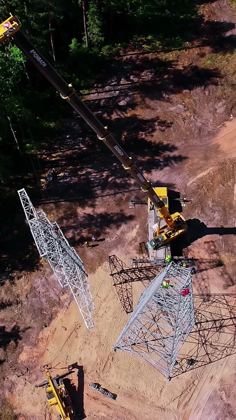 Overhead view of electric grid tower build, vertical Video stock 337016836