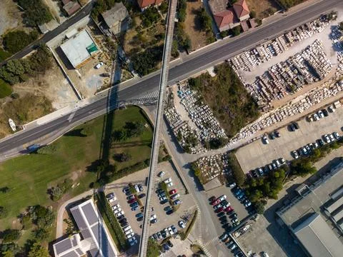 Overhead view of elevated rail line crossing busy roadway near stone depot... Stock Photos
