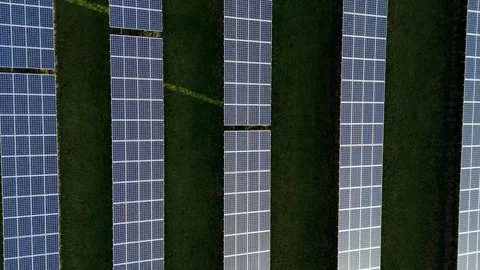 Overhead view of an expansive clean energy solar power plant integrated into a Stock Footage 337004995