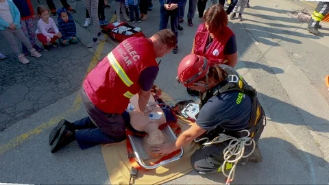 Overhead view of first responders switching sides to do chest compressions Stock Footage 96676271